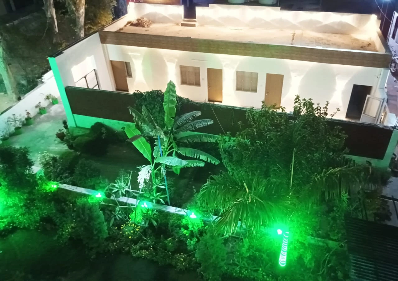 Night aerial view of Basant Niwas rooms and lush courtyard garden